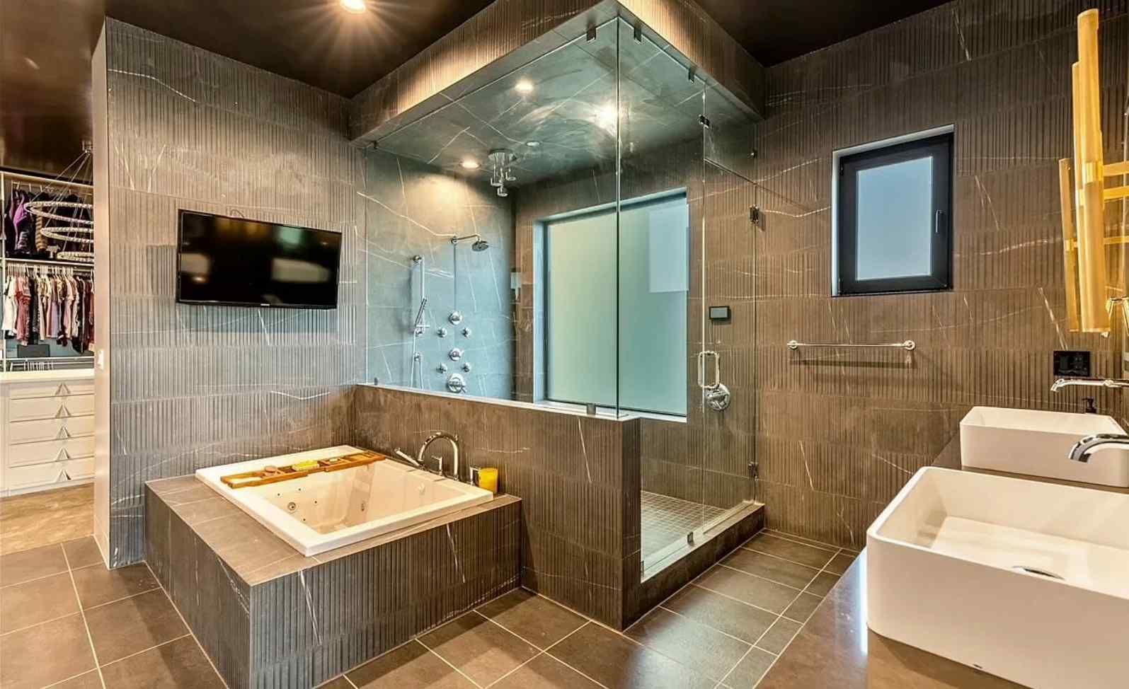 A bathroom with a tub , sink , and shower.