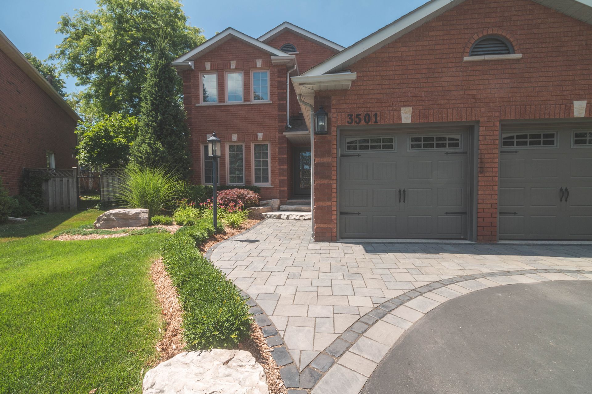 A brick house with a gray garage door