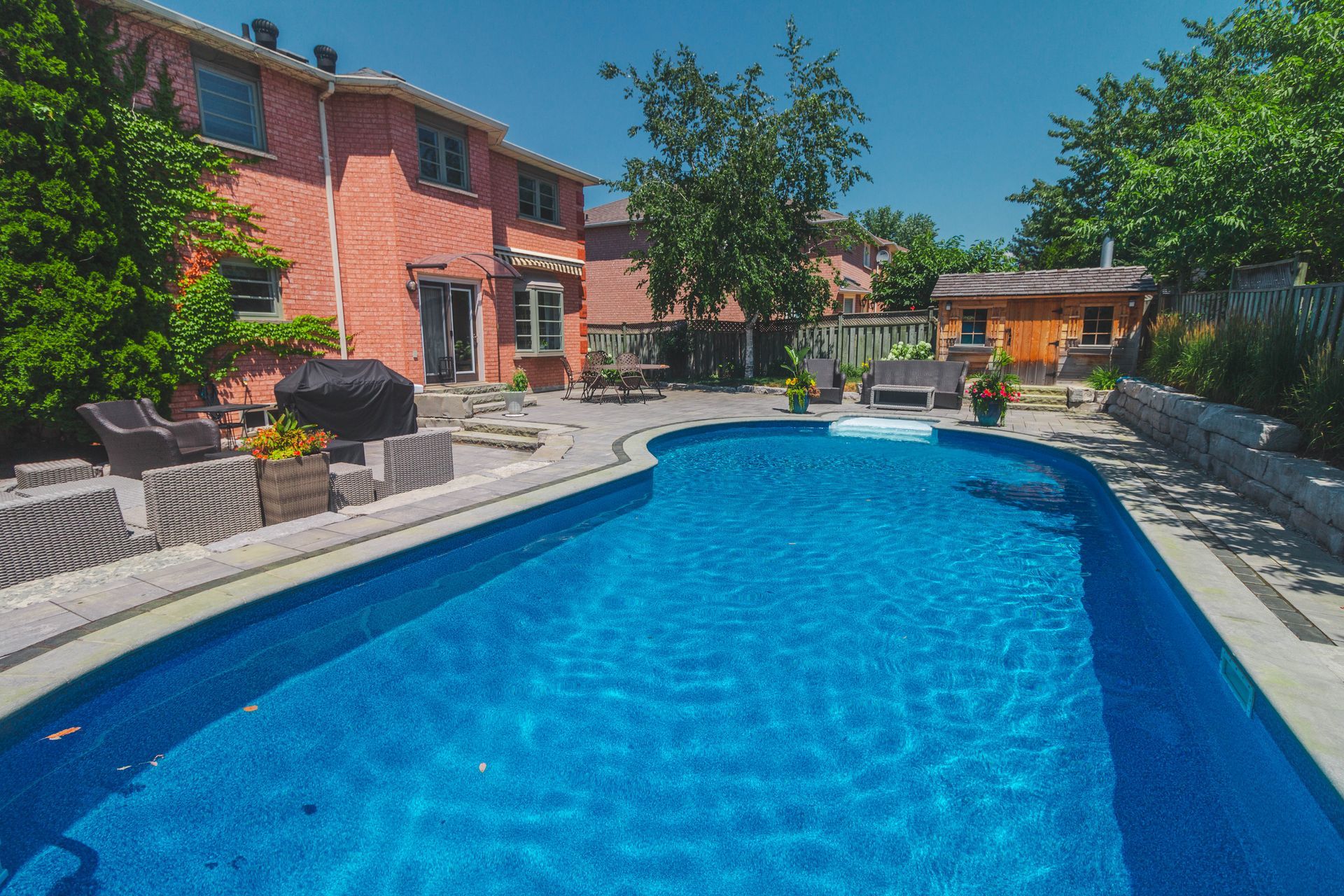 A large swimming pool in the backyard of a house
