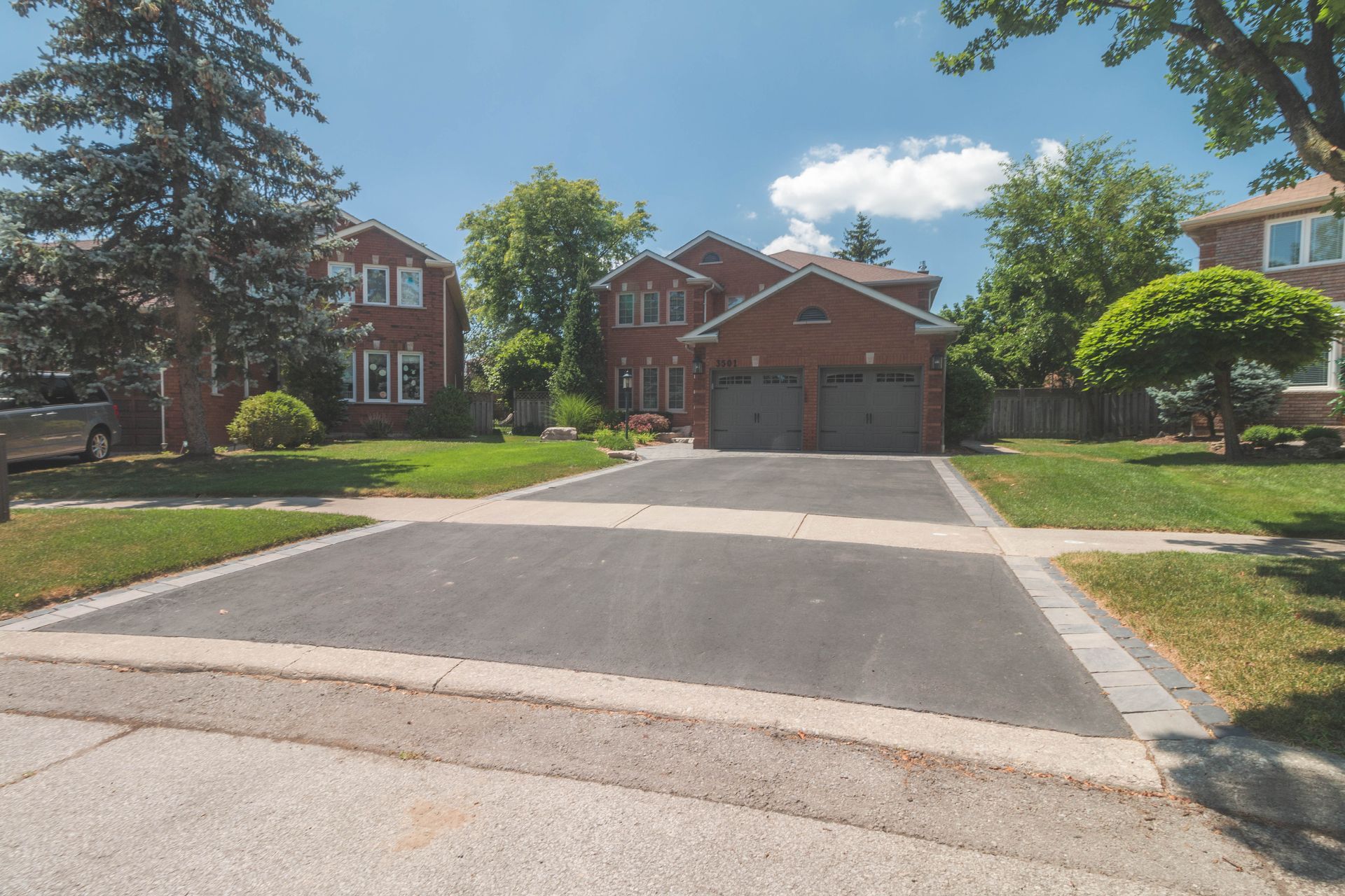 A driveway leading to a house with the number 168 on it