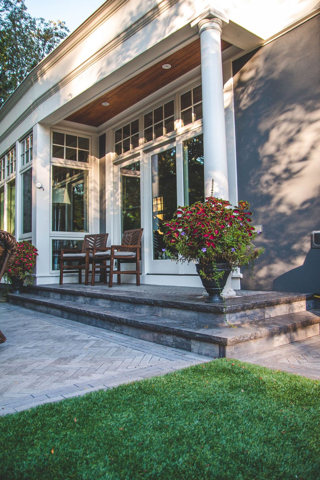 A large house with a porch and stairs leading up to it.