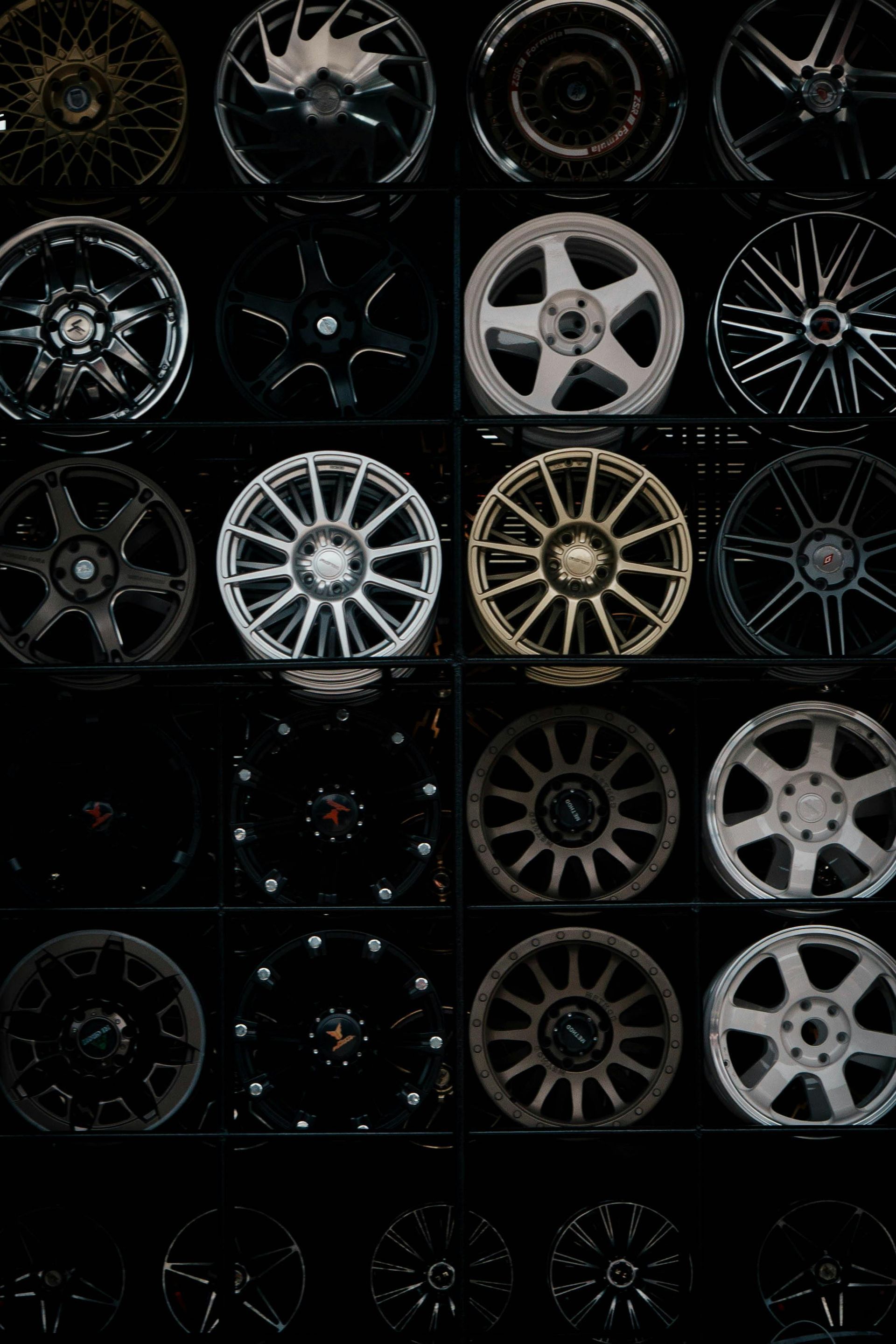 Collage of car rims and wheel designs on a dark background