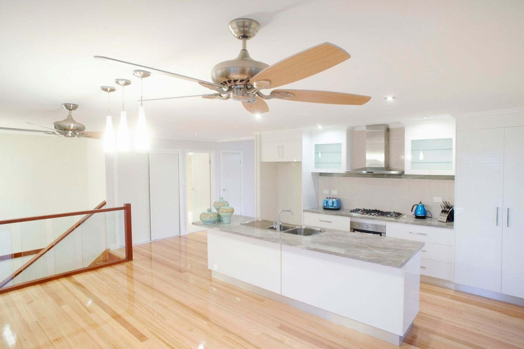 A Kitchen With a Ceiling Fan and Wooden Floors — Pro-Jax Pty Ltd in Bohle, QLD