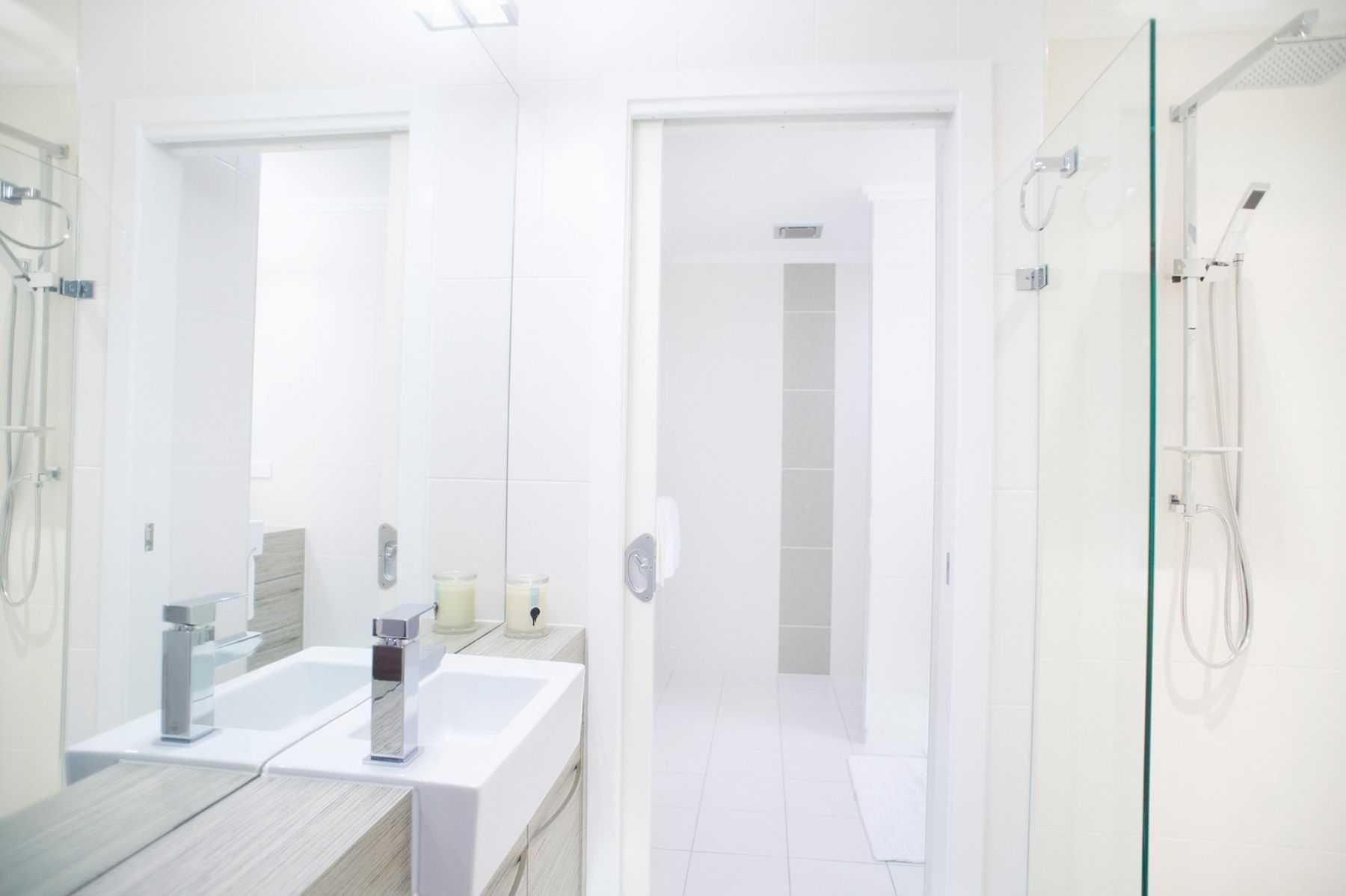 A Bathroom With a Sink, Mirror and Shower — Pro-Jax Pty Ltd in Bohle, QLD