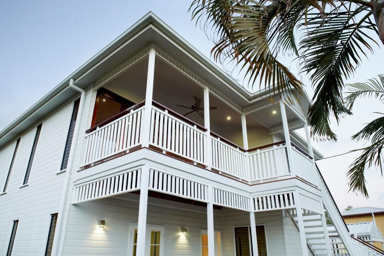 A White House With a Balcony and Stairs is Surrounded by Palm Trees — Pro-Jax Pty Ltd in Bohle, QLD