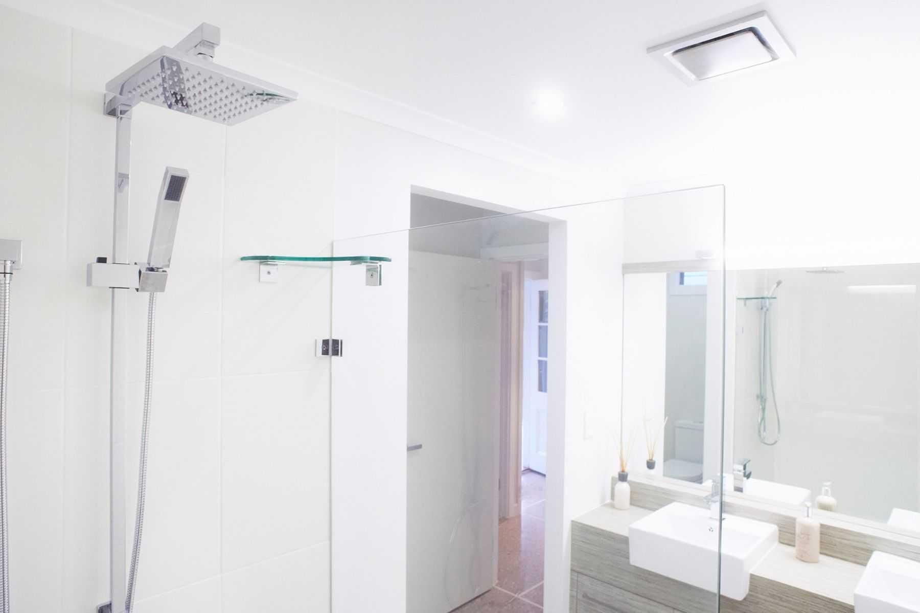 A Bathroom With a Shower, Sink, Mirror and Shower Head — Pro-Jax Pty Ltd in Bohle, QLD