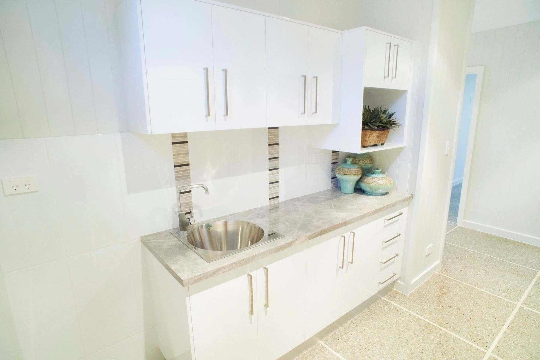 A Kitchen With White Cabinets and a Sink — Pro-Jax Pty Ltd in Bohle, QLD
