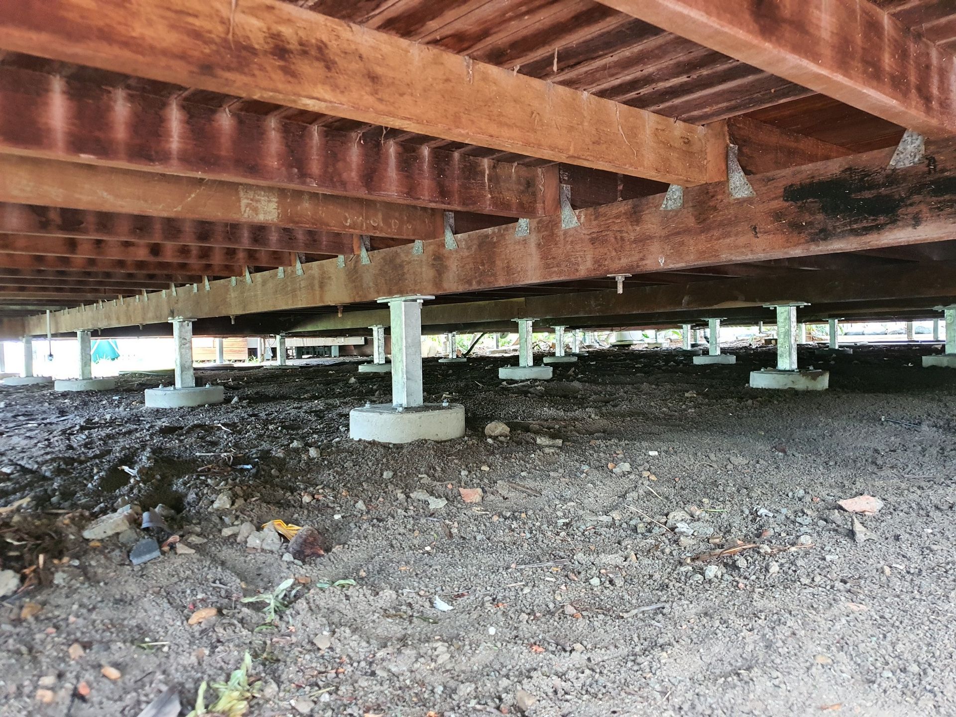 Wooden House Foundation With Beams Supported by Concrete Pillars on Dirt Ground — Pro-Jax Pty Ltd in Bohle, QLD