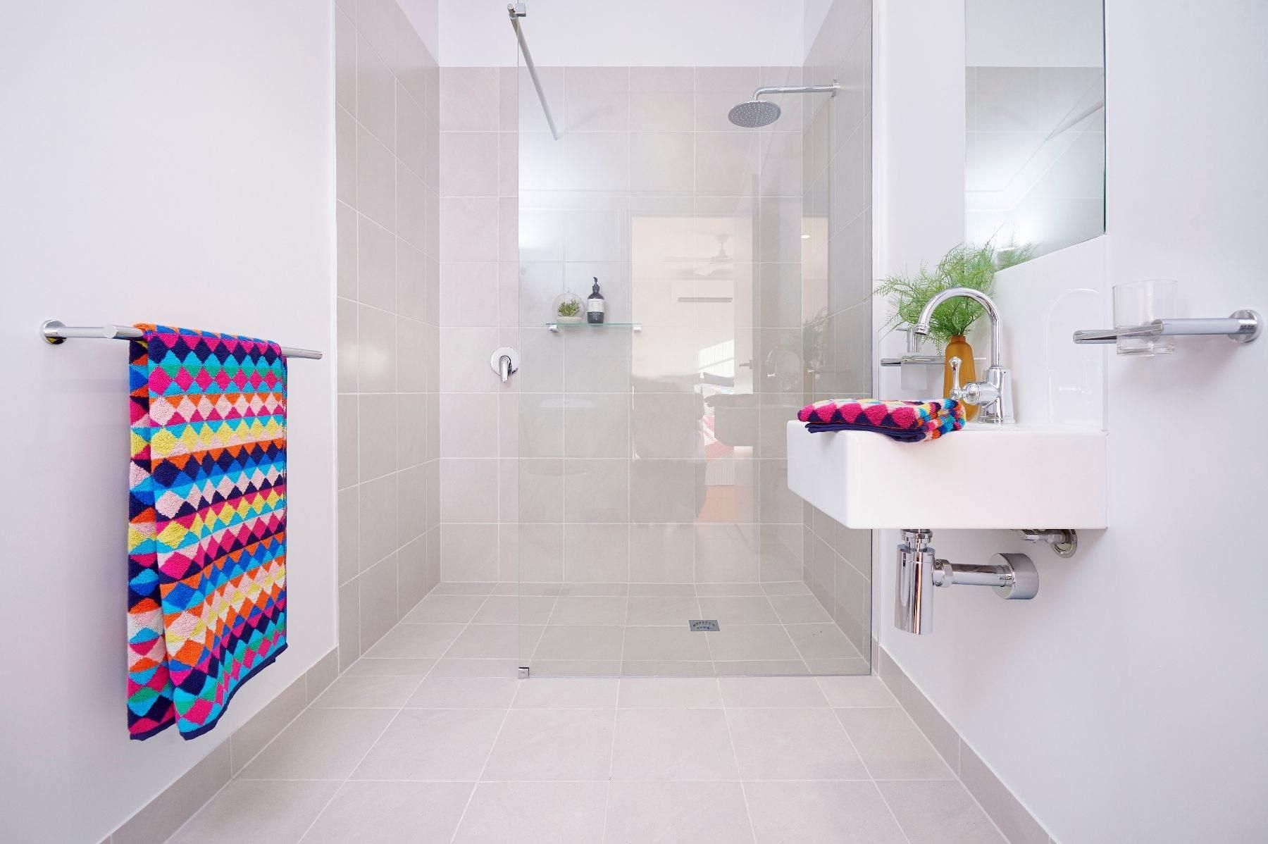 A Bathroom With a Walk in Shower, Sink and Mirror — Pro-Jax Pty Ltd in Bohle, QLD