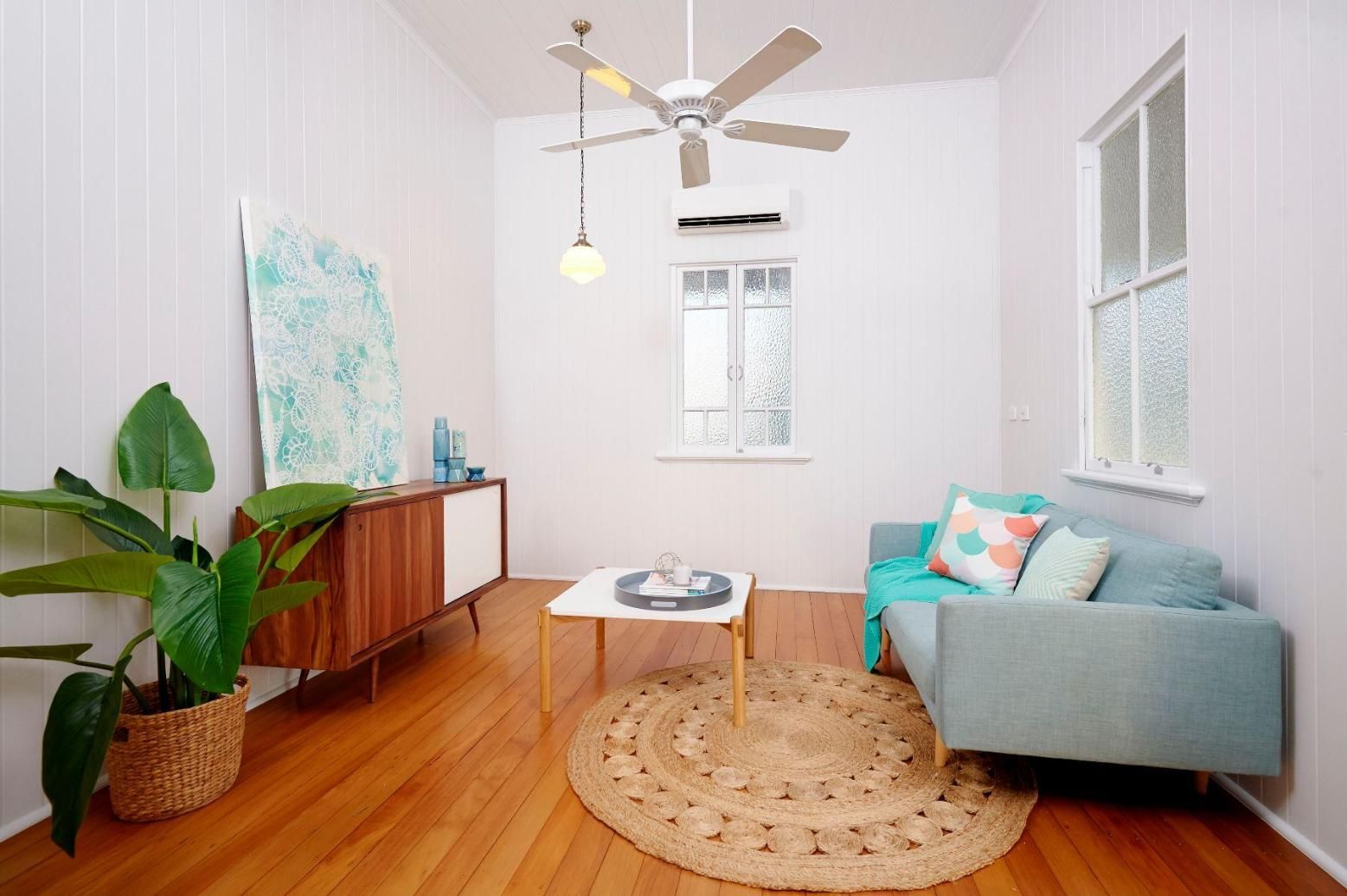 A Living Room With a Couch, Coffee Table, and Ceiling Fan — Pro-Jax Pty Ltd in Bohle, QLD
