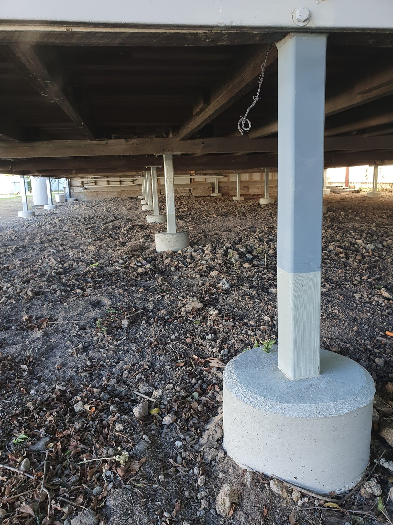 Concrete Supports Under a Structure, on a Gravel Surface — Pro-Jax Pty Ltd in Bohle, QLD