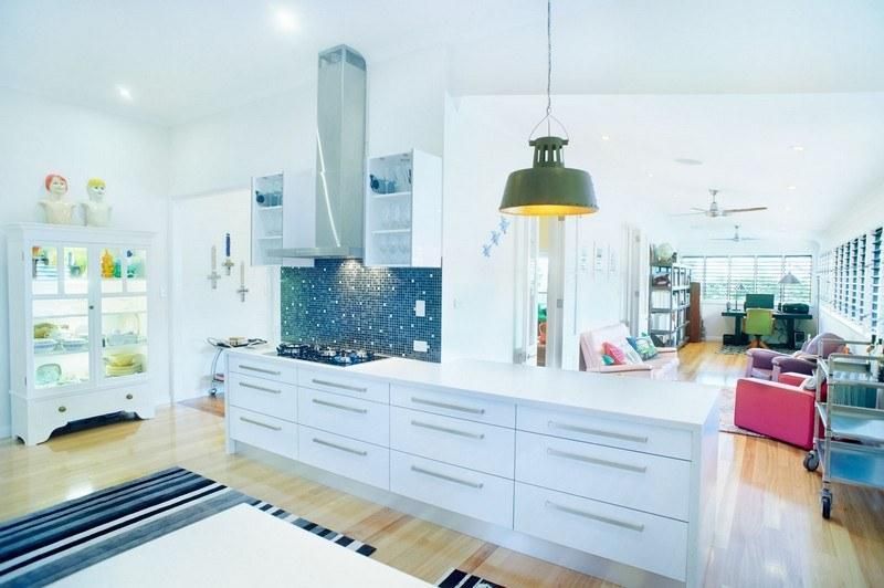 A Kitchen With White Cabinets and a Green Light Hanging From the Ceiling — Pro-Jax Pty Ltd in Bohle, QLD