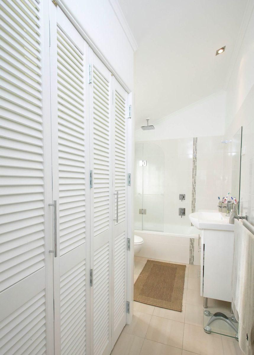 A Bathroom With White Shutters and a Bathtub — Pro-Jax Pty Ltd in Bohle, QLD