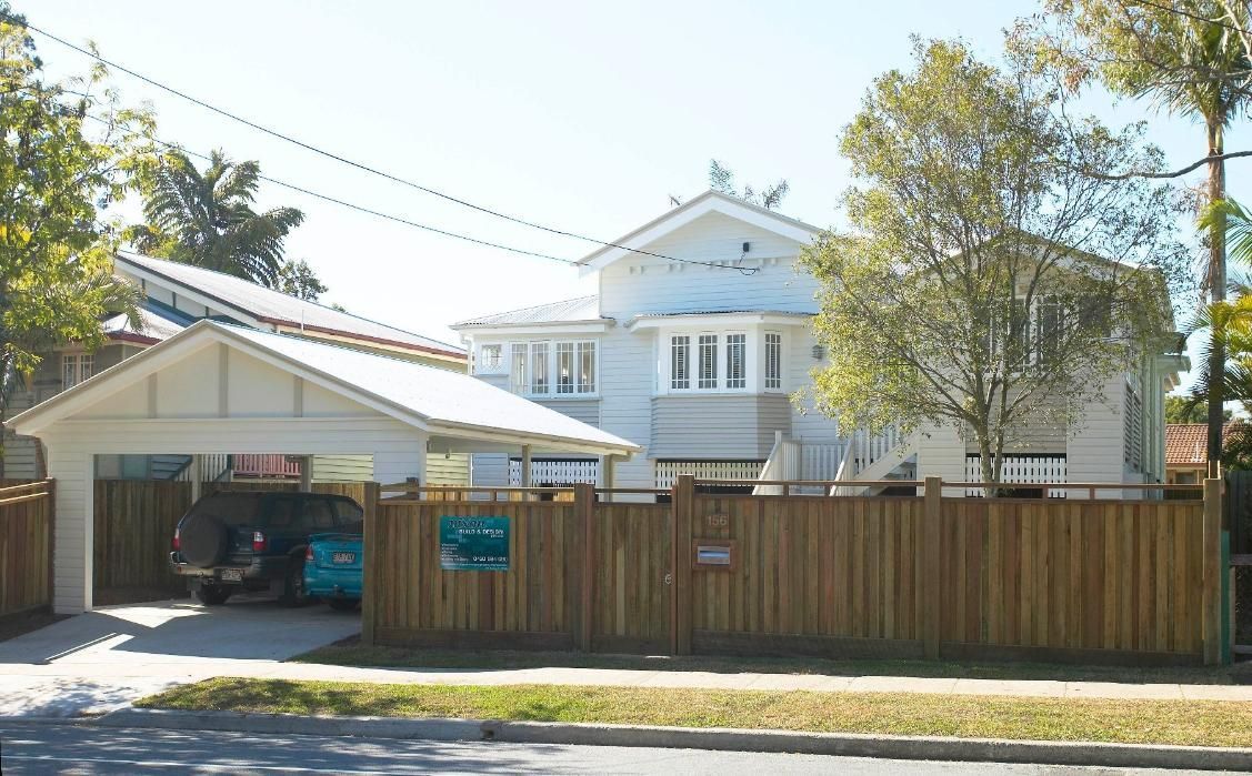 A White House With a Wooden Fence Around It — Pro-Jax Pty Ltd in Bohle, QLD