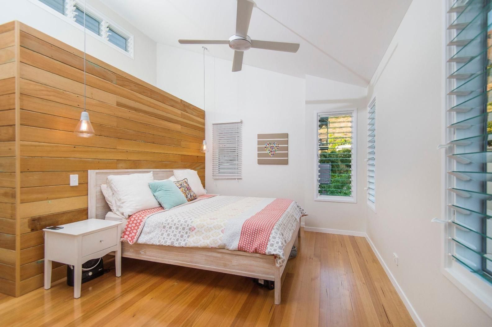 A Bedroom With a Bed, Nightstand, and Ceiling Fan — Pro-Jax Pty Ltd in Bohle, QLD