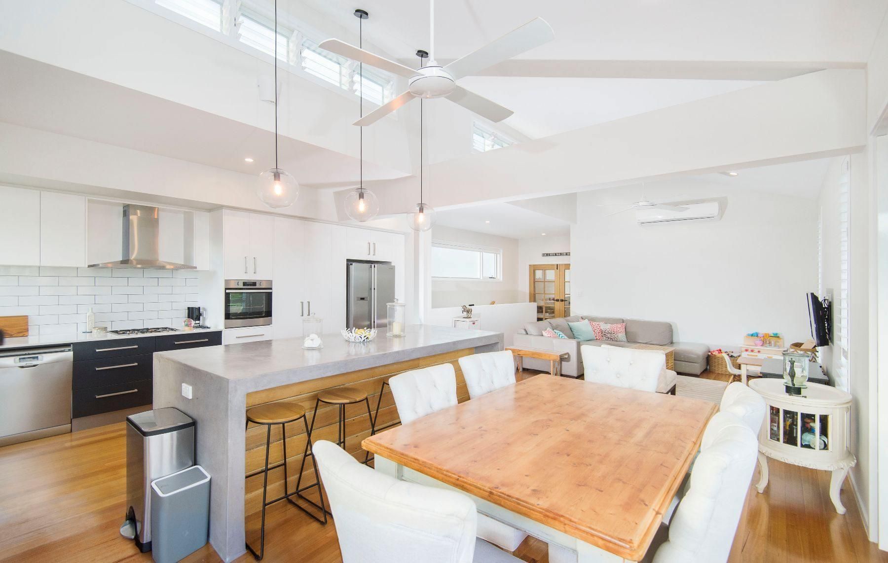 A Kitchen With a Dining Table and Chairs and a Ceiling Fan — Pro-Jax Pty Ltd in Bohle, QLD