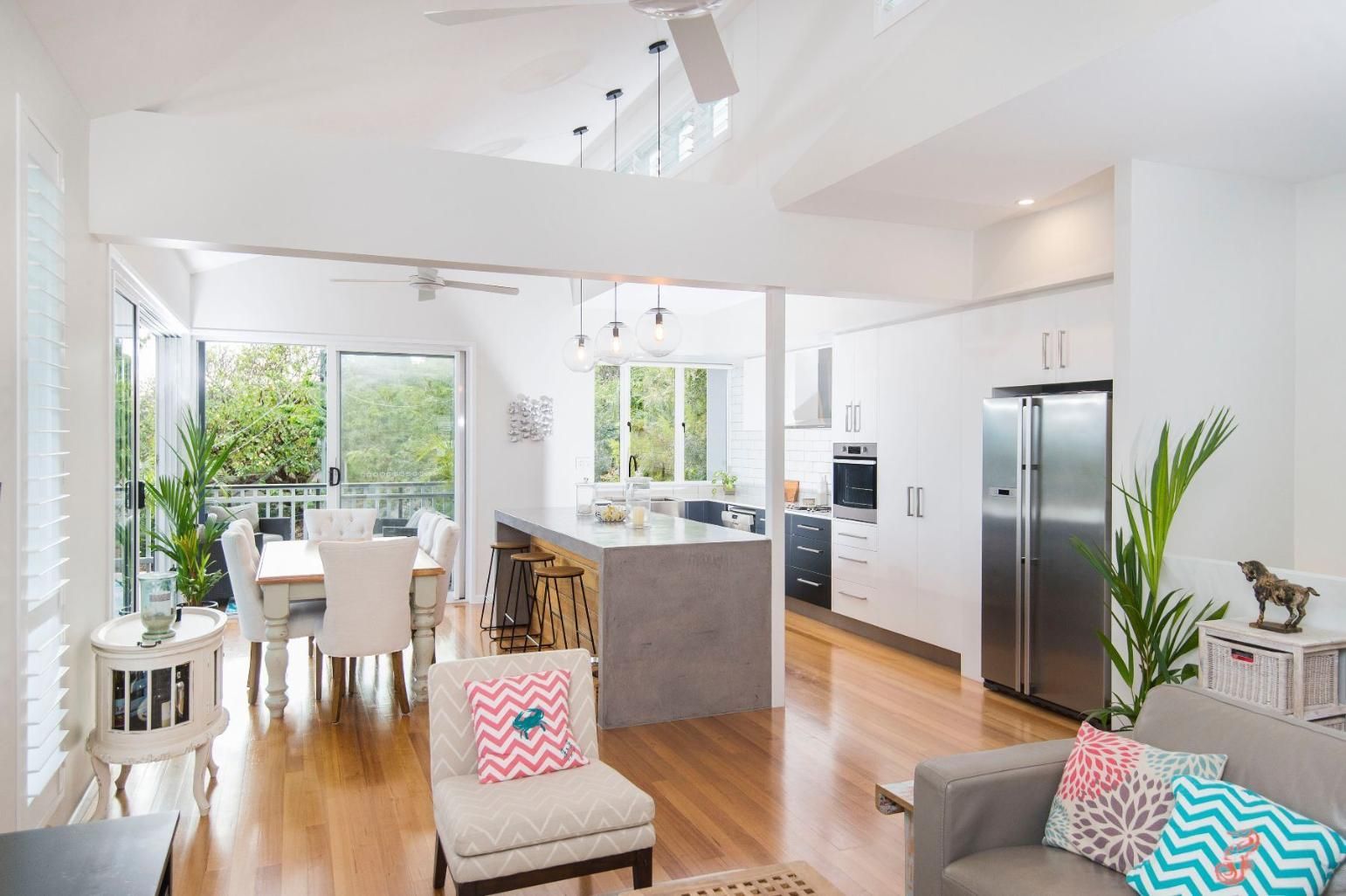 A Living Room With a Couch, Chair, Table and Refrigerator — Pro-Jax Pty Ltd in Bohle, QLD