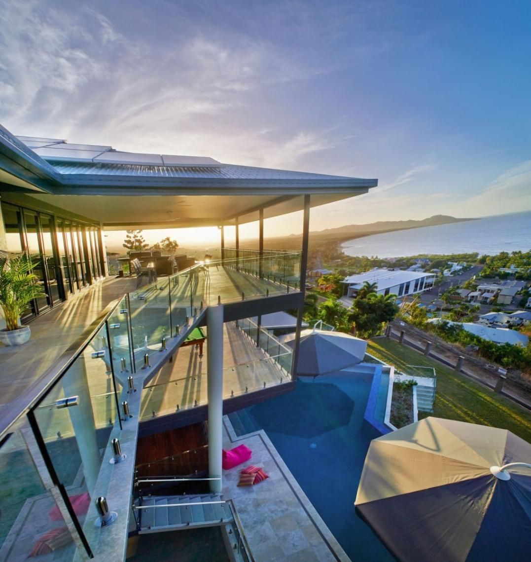 An Aerial View of a House With a Swimming Pool and Umbrellas — Pro-Jax Pty Ltd in Bohle, QLD