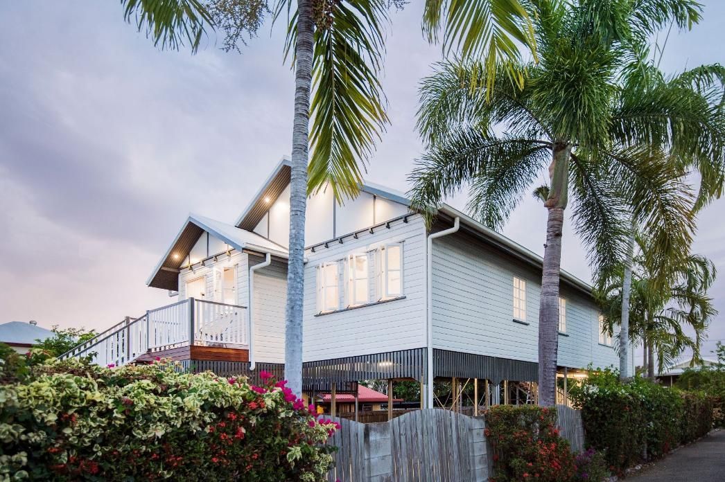 A White House With Palm Trees in Front of It — Pro-Jax Pty Ltd in Bohle, QLD