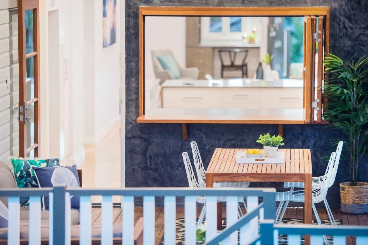 A Patio With a Table and Chairs and a Large Mirror on the Wall — Pro-Jax Pty Ltd in Bohle, QLD