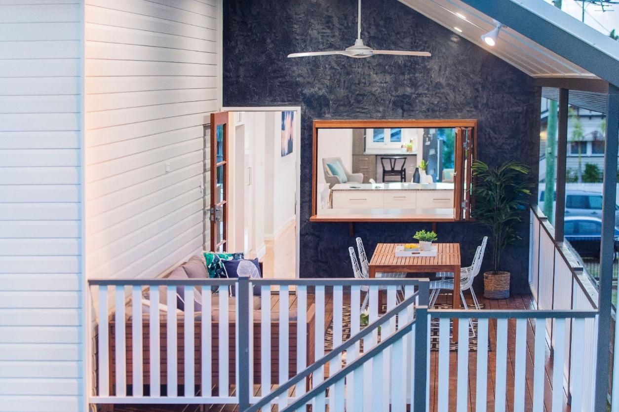 A Balcony With a Table and Chairs and a Ceiling Fan — Pro-Jax Pty Ltd in Bohle, QLD