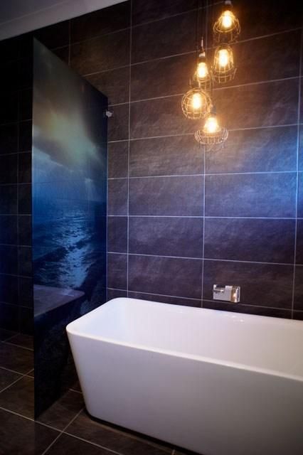 A Bathroom With a Bathtub and a Picture of the Ocean on the Wall — Pro-Jax Pty Ltd in Bohle, QLD