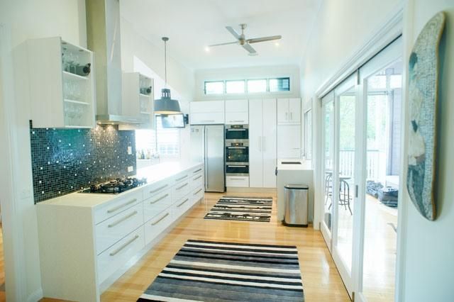 A Kitchen With White Cabinets and Stainless Steel Appliances — Pro-Jax Pty Ltd in Bohle, QLD