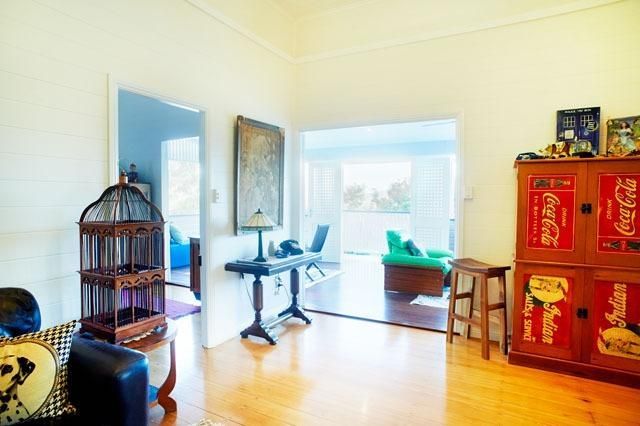 A Living Room With a Bird Cage and a Coca Cola Cabinet — Pro-Jax Pty Ltd in Bohle, QLD