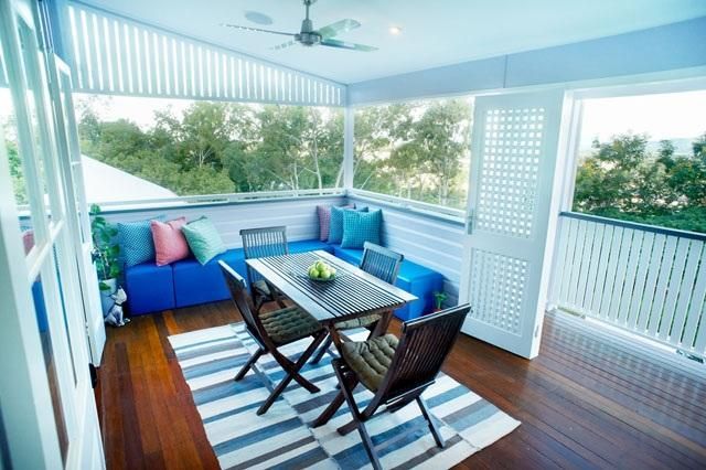 A Balcony With a Table and Chairs and a Blue Couch — Pro-Jax Pty Ltd in Bohle, QLD