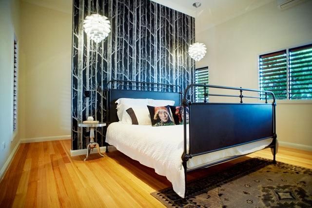 A Bedroom With a Black Bed and White Sheets — Pro-Jax Pty Ltd in Bohle, QLD