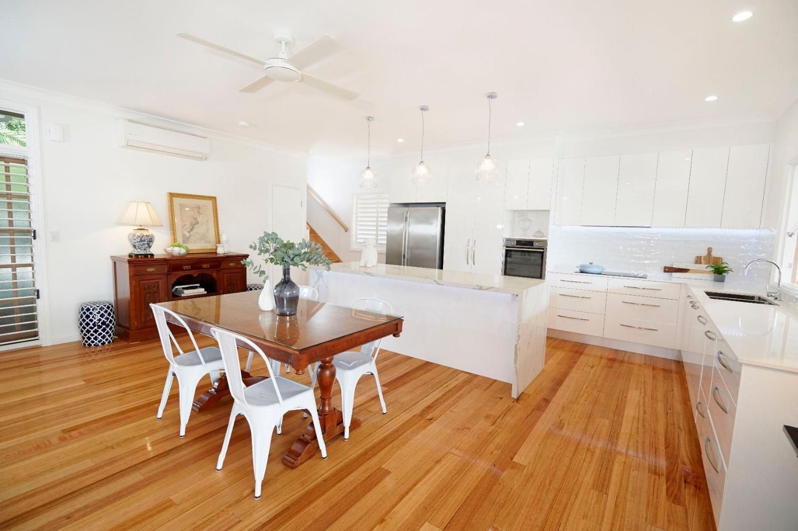 A Kitchen With a Wooden Table and Chairs and a Ceiling Fan — Pro-Jax Pty Ltd in Bohle, QLD