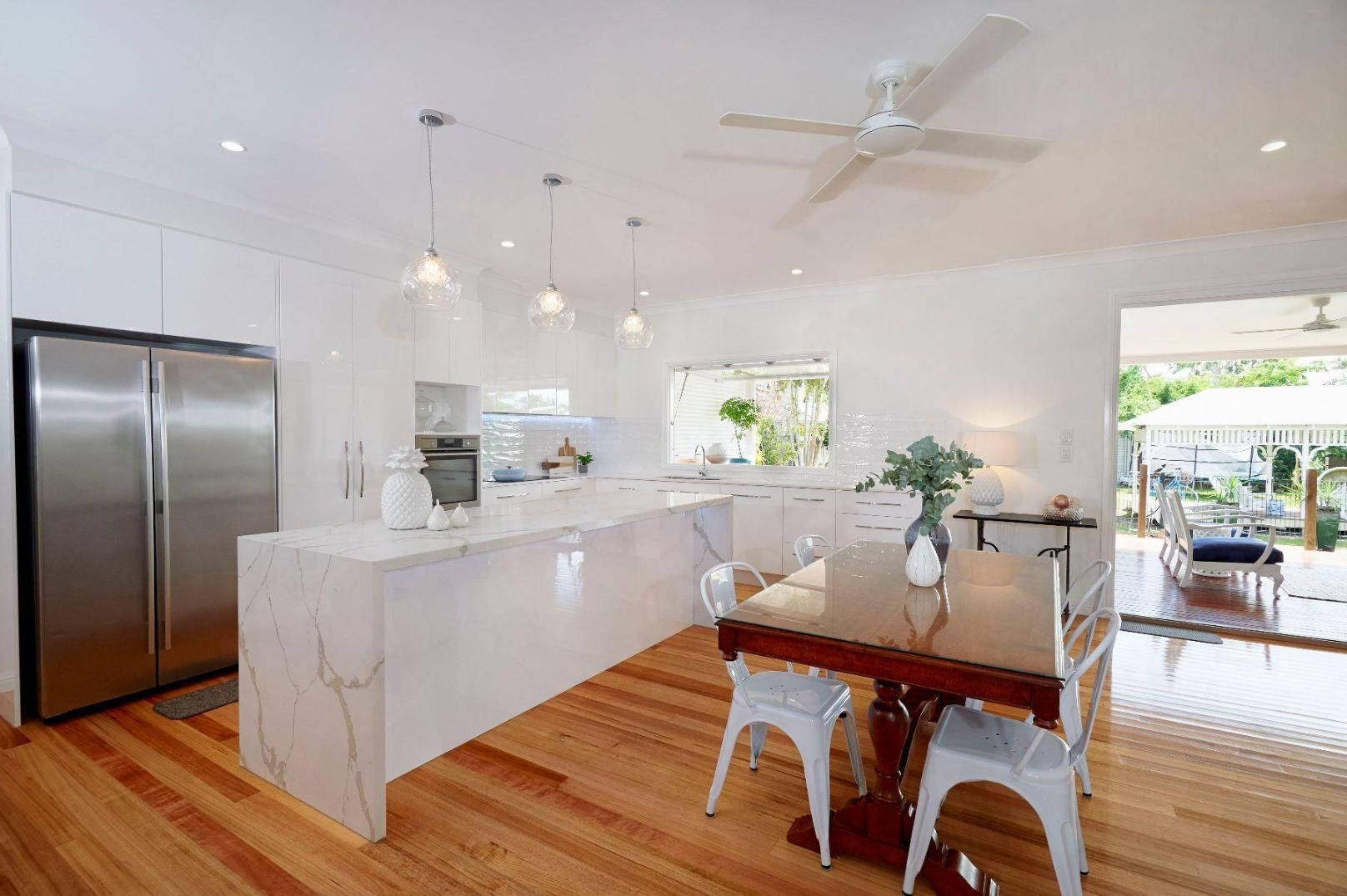 A Kitchen With a Table and Chairs and a Ceiling Fan — Pro-Jax Pty Ltd in Bohle, QLD