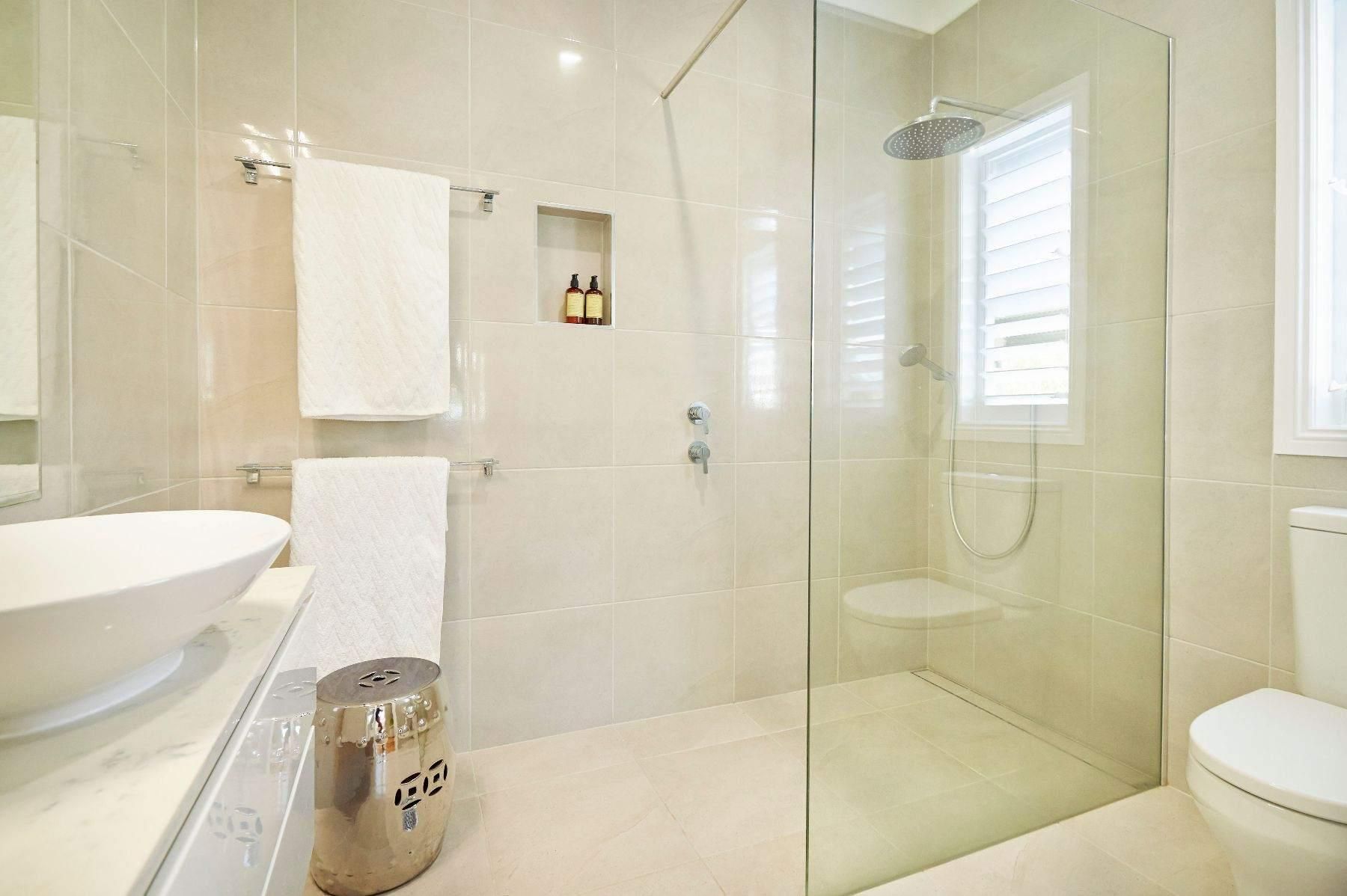 A Bathroom With a Walk in Shower, Toilet, Sink and Mirror — Pro-Jax Pty Ltd in Bohle, QLD