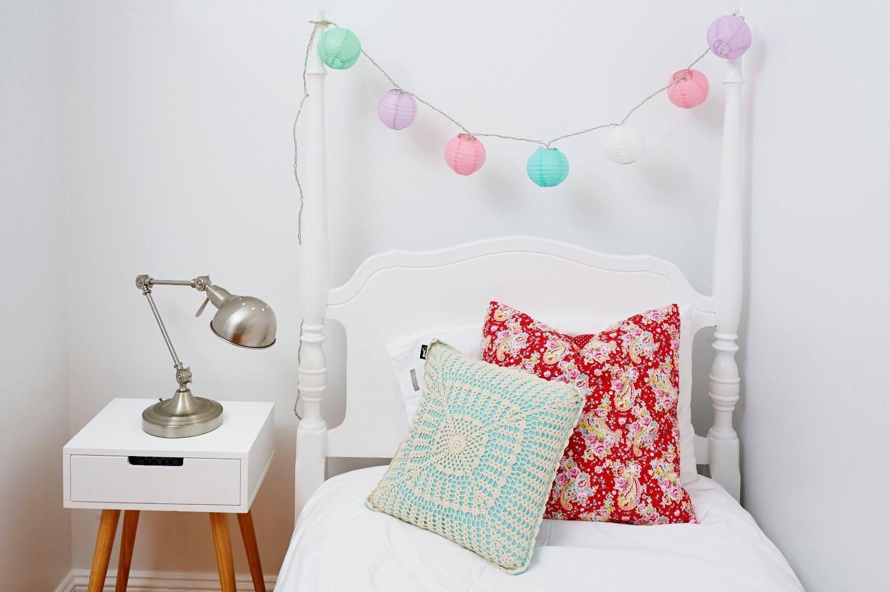A Bed With a Lamp and Pillows on It in a Bedroom — Pro-Jax Pty Ltd in Bohle, QLD