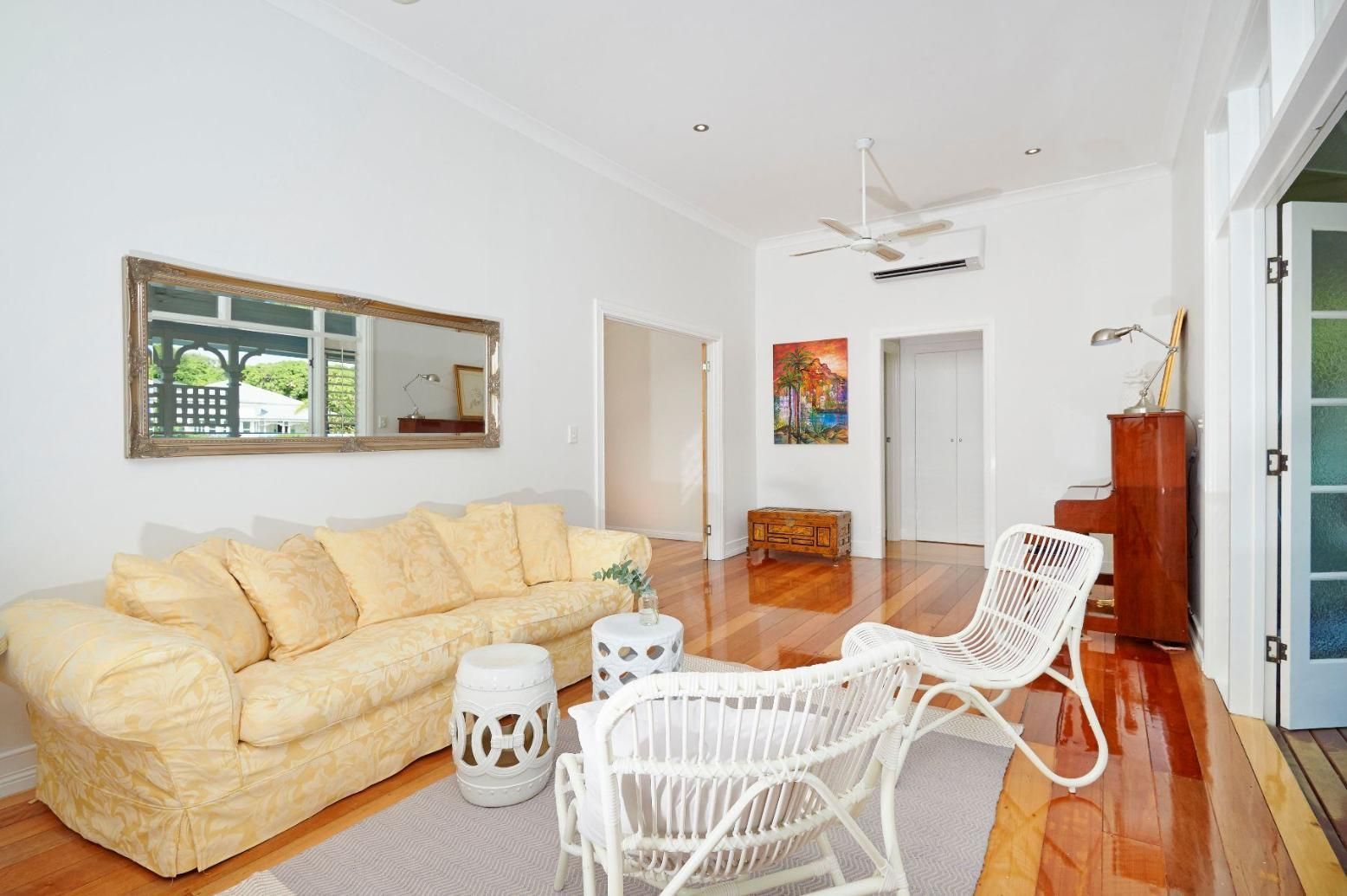 A Living Room With a Couch, Chairs, Tables and a Mirror — Pro-Jax Pty Ltd in Bohle, QLD