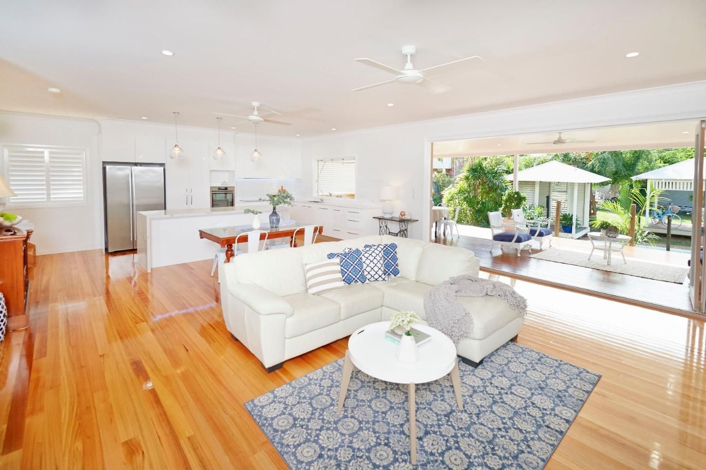 A Living Room With a White Couch and a Blue Rug — Pro-Jax Pty Ltd in Bohle, QLD