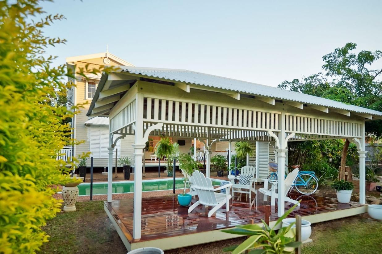 A White Gazebo With Chairs and Tables in Front of a House — Pro-Jax Pty Ltd in Bohle, QLD