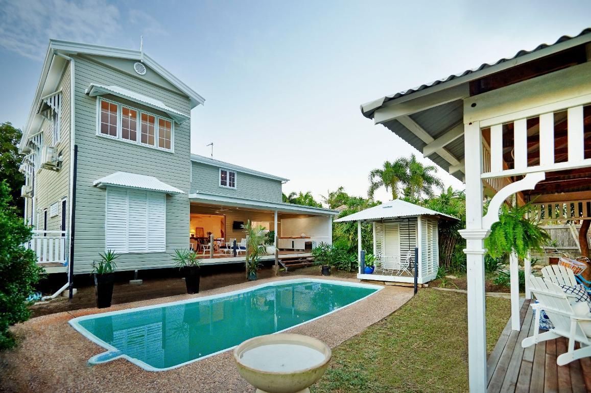 A Large House With a Swimming Pool in Front of It — Pro-Jax Pty Ltd in Bohle, QLD