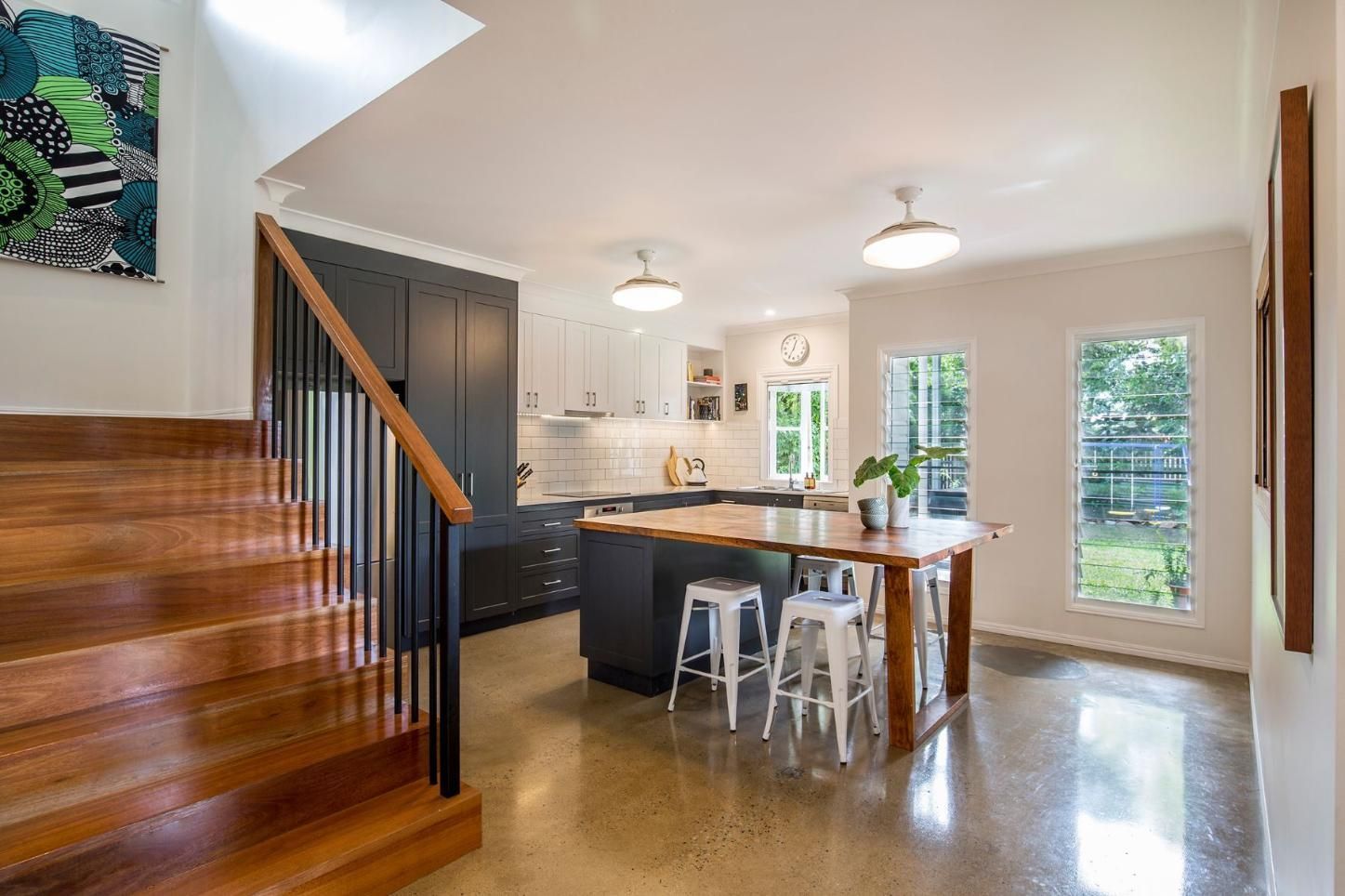 A Kitchen With a Table and Stairs Leading Up to It — Pro-Jax Pty Ltd in Bohle, QLD