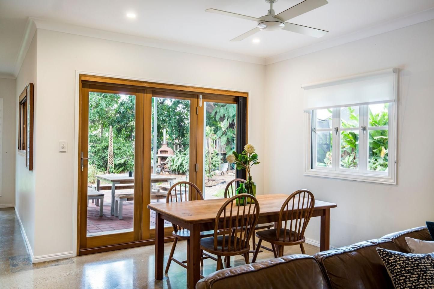 A Living Room With a Table and Chairs and a Ceiling Fan — Pro-Jax Pty Ltd in Bohle, QLD