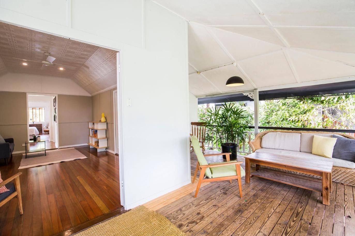 A Living Room With a Wooden Floor and a Couch and Chairs — Pro-Jax Pty Ltd in Bohle, QLD
