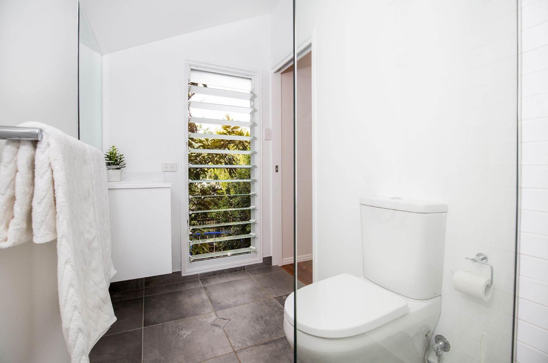 A Bathroom With a Toilet, Sink, and Shower — Pro-Jax Pty Ltd in Bohle, QLD