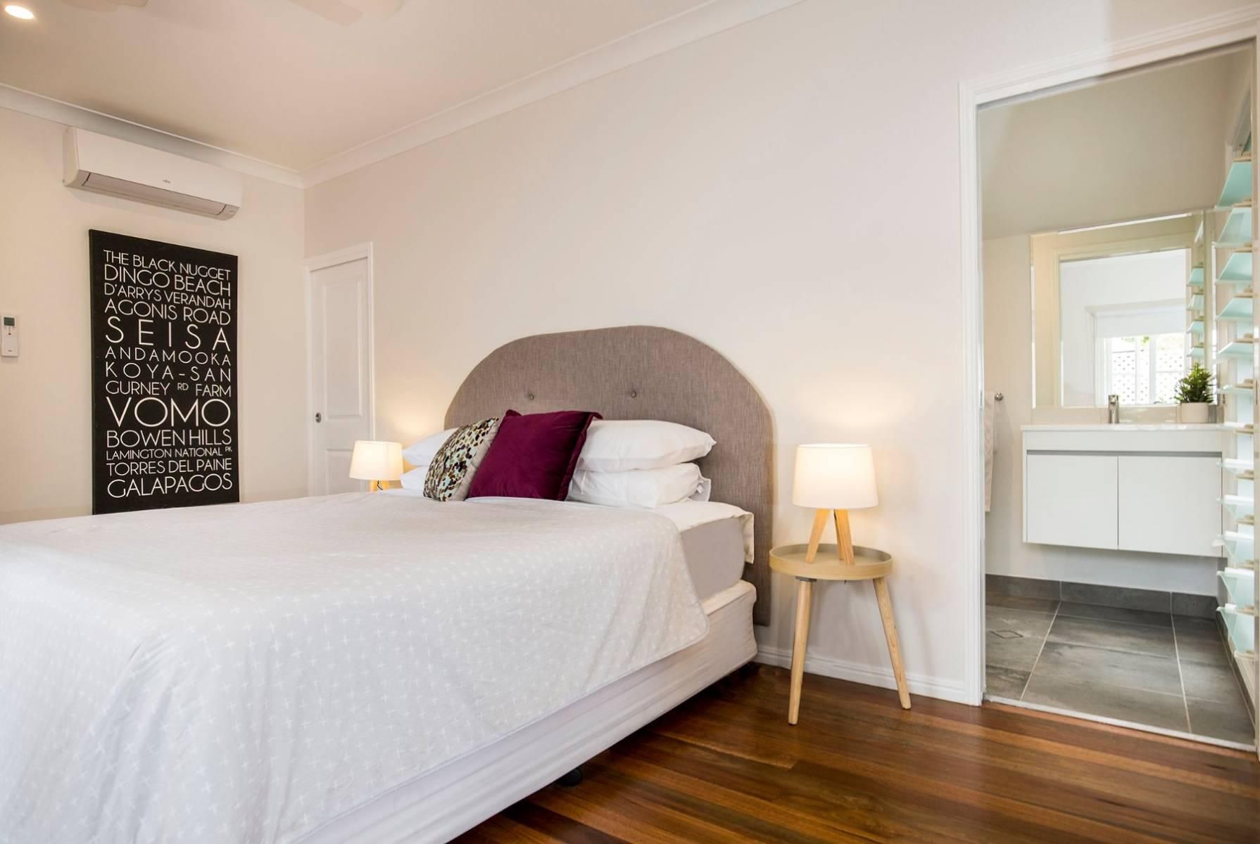 A Bedroom With a Bed, Nightstand, Lamps and a Bathroom — Pro-Jax Pty Ltd in Bohle, QLD