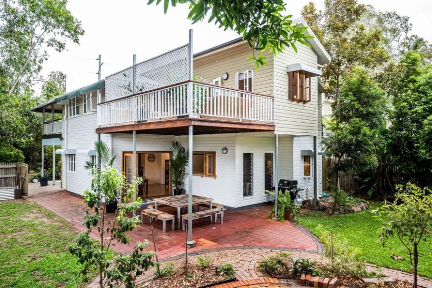 A White House With a Large Deck and a Picnic Table in Front of It — Pro-Jax Pty Ltd in Bohle, QLD