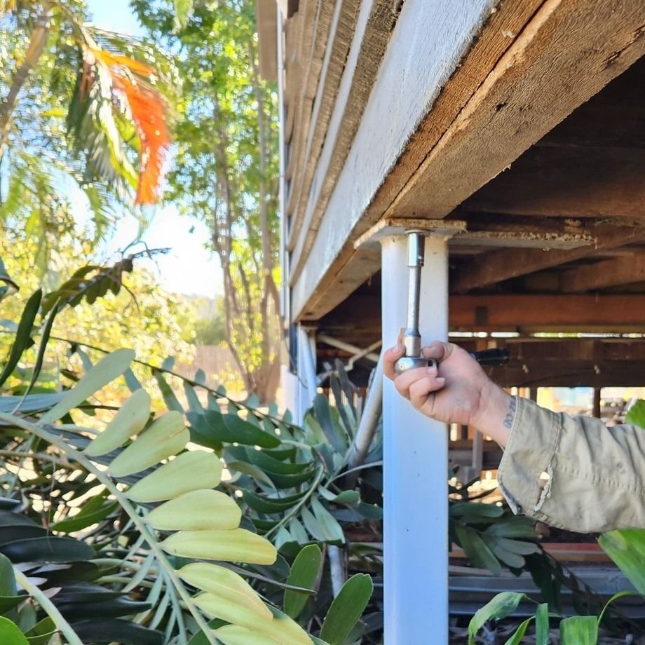 Person Using a Wrench on a House Support Column — Pro-Jax Pty Ltd in Bohle, QLD