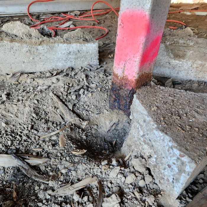 A Red Marker is Painted on a Concrete Post  — Pro-Jax Pty Ltd in Bohle, QLD