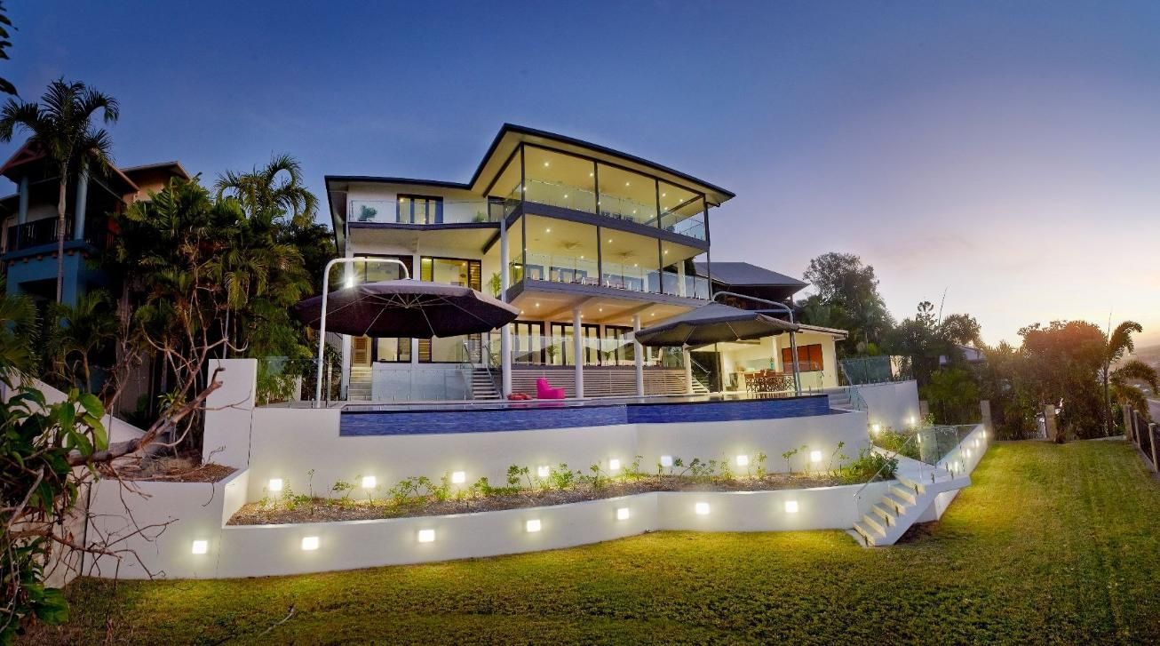 A Large House With a Swimming Pool is Sitting on Top of a Hill — Pro-Jax Pty Ltd in Bohle, QLD