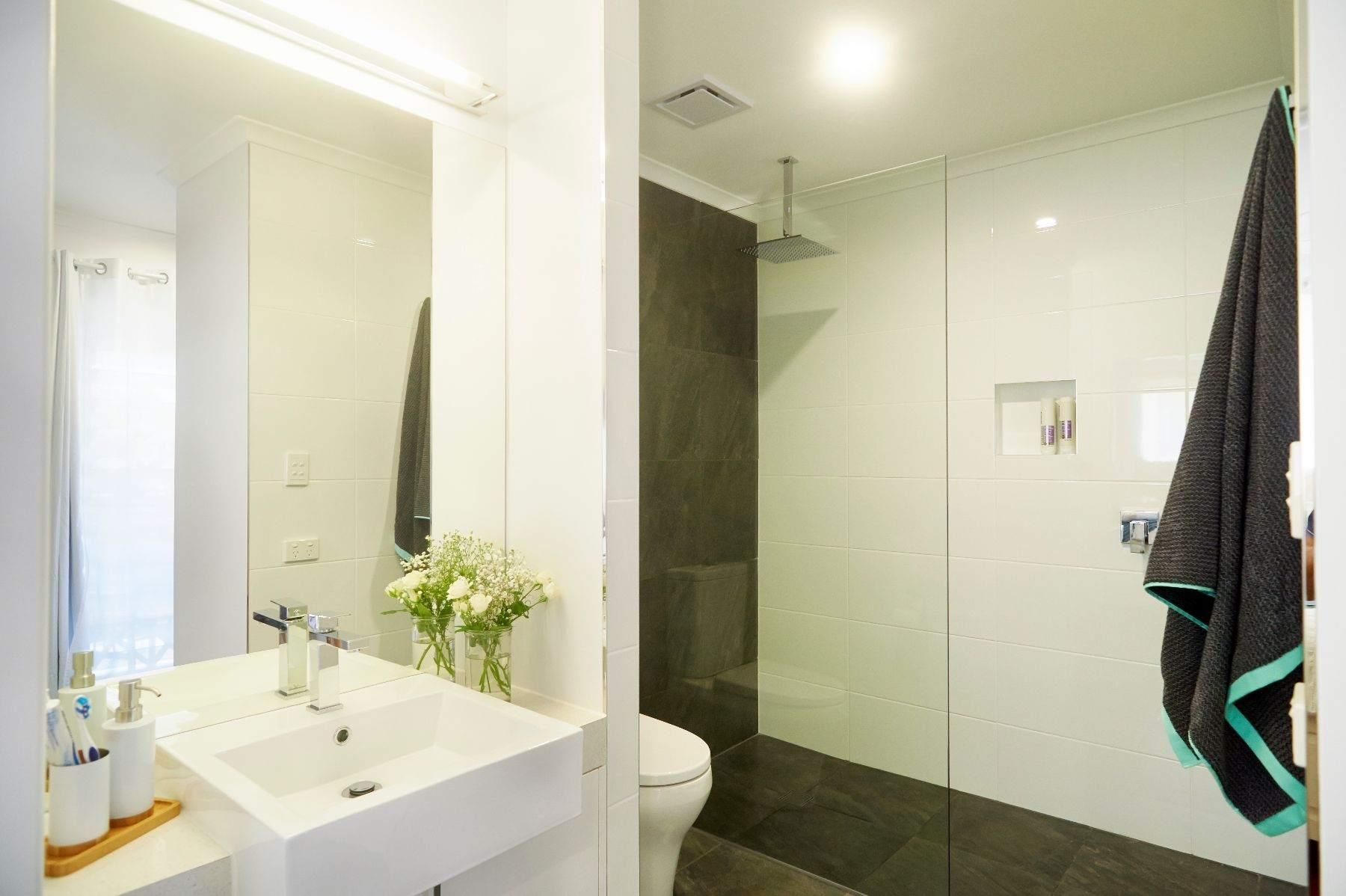 A Bathroom With a Sink, Toilet, Shower and Mirror — Pro-Jax Pty Ltd in Bohle, QLD