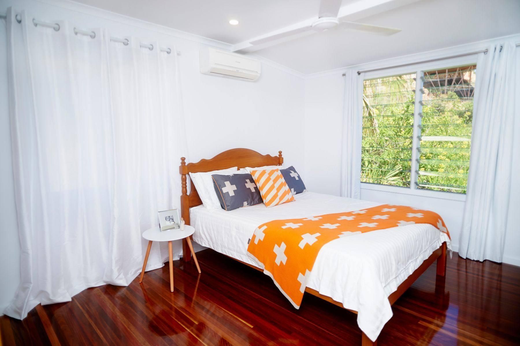 A Bedroom With a Bed, a Nightstand, and a Window — Pro-Jax Pty Ltd in Bohle, QLD