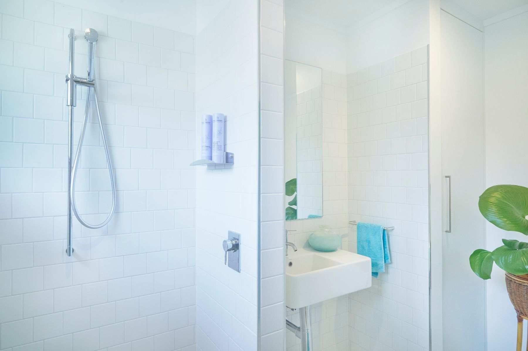 A Bathroom With a Sink, Shower and Mirror — Pro-Jax Pty Ltd in Bohle, QLD